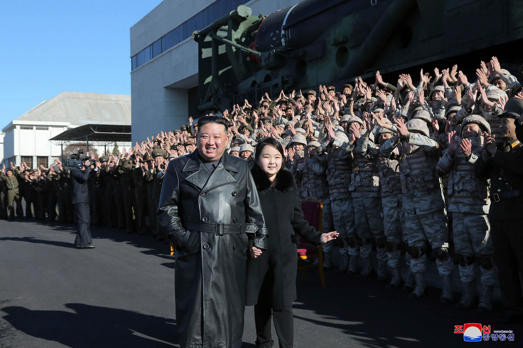 Kim Jong-Un och dottern Ju-Ae tillsammans med militärer som arbetar med robotprogrammet Hwasong-17. Bilden är odaterad, men publicerades på söndagen.