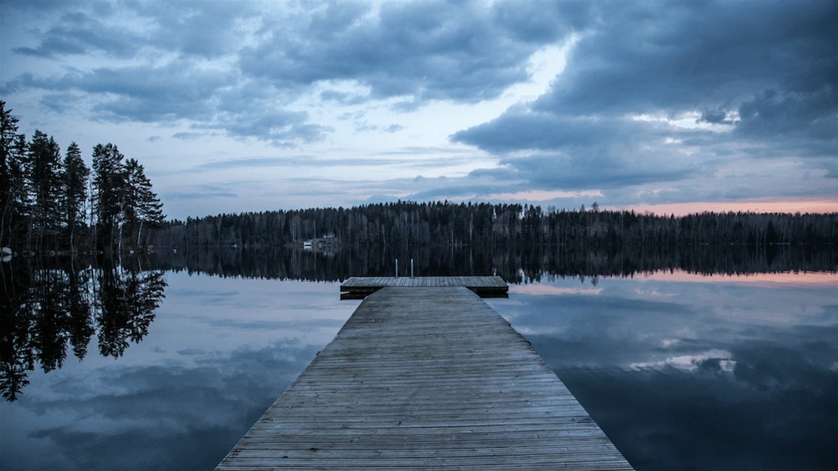 En träbrygga vid en sjö i Finland