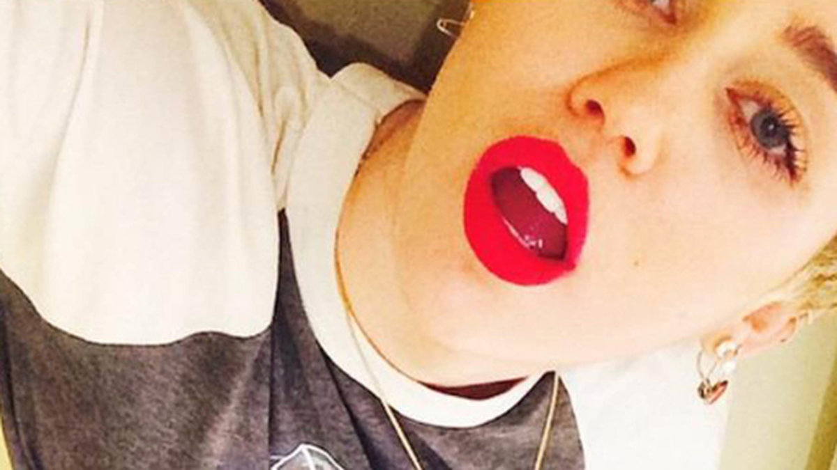 Miley är festfin i rött läppstift. 