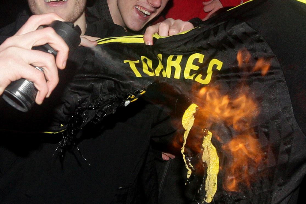 Här bränner Liverpoolfansen Torres gamla tröja.