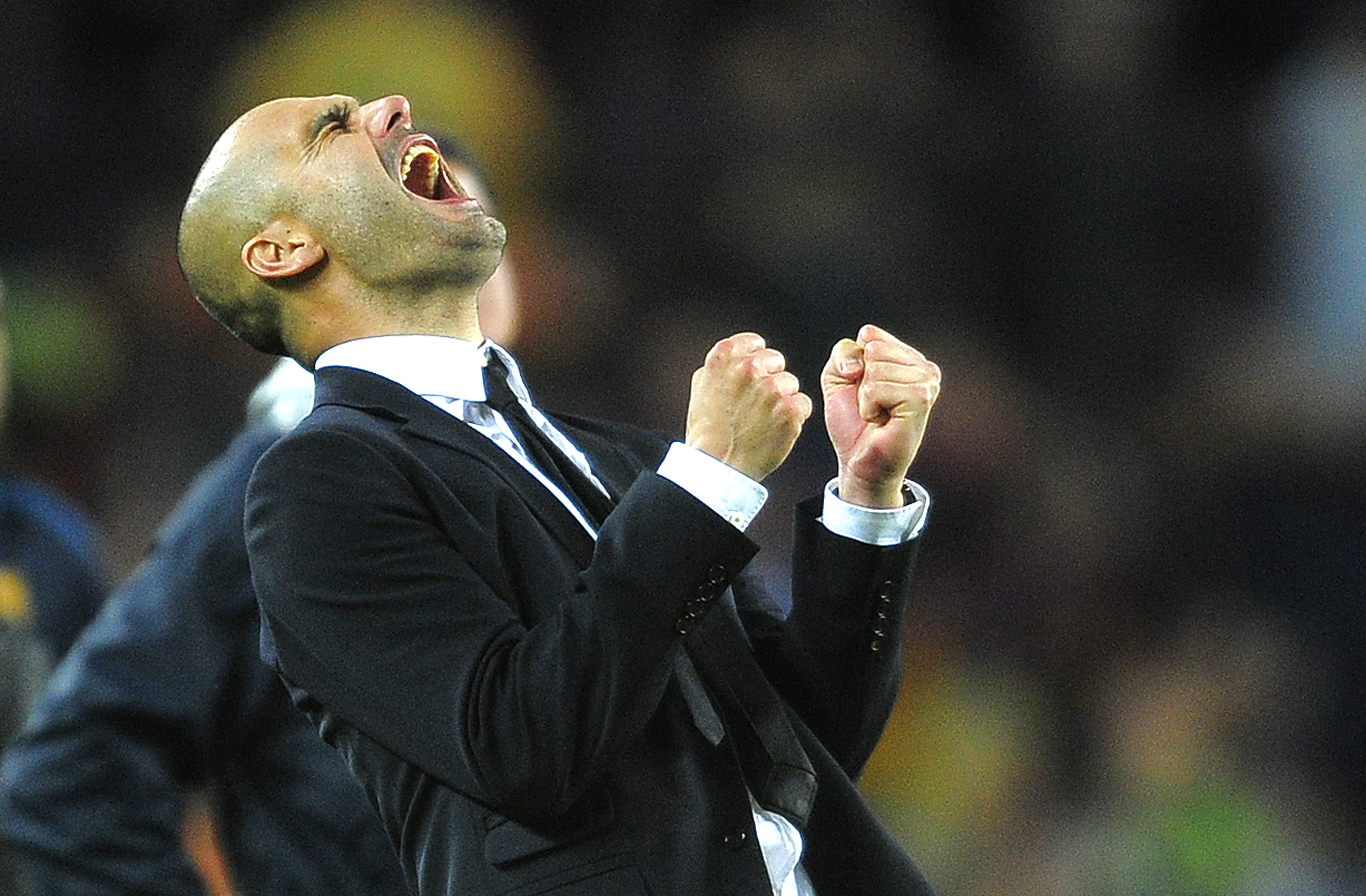 Pep Guardiola skriker ut sin glädje.