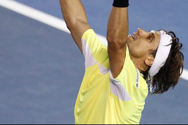 Ferrer sträcker upp händerna i jubel efter segern över Nadal.