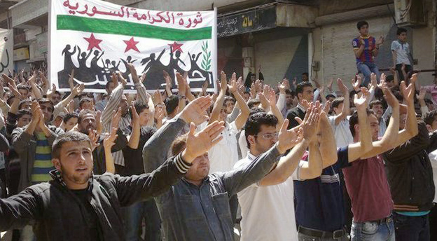 Syrier ropar slagord under en demonstration i Idlib i norra Syrien den 8 april.