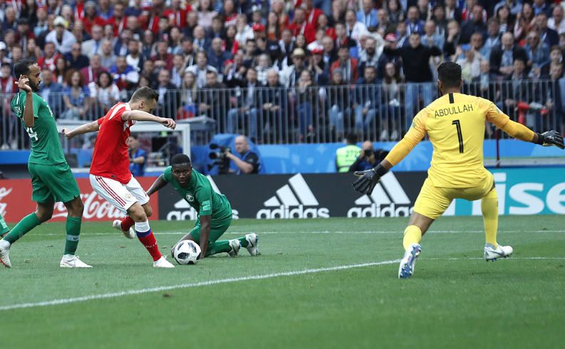 En spelare i Ryssland skjuter mot mål i en match mot Saudiarabien. En spelare i Ryssland skjuter mot mål i en match mot Saudiarabien.