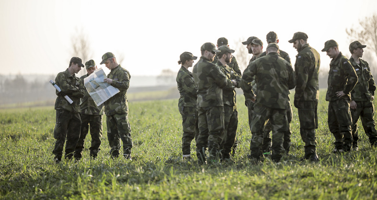 Militars on a meadow.